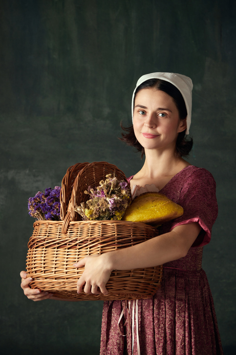 young woman wearing bonnet holding basket