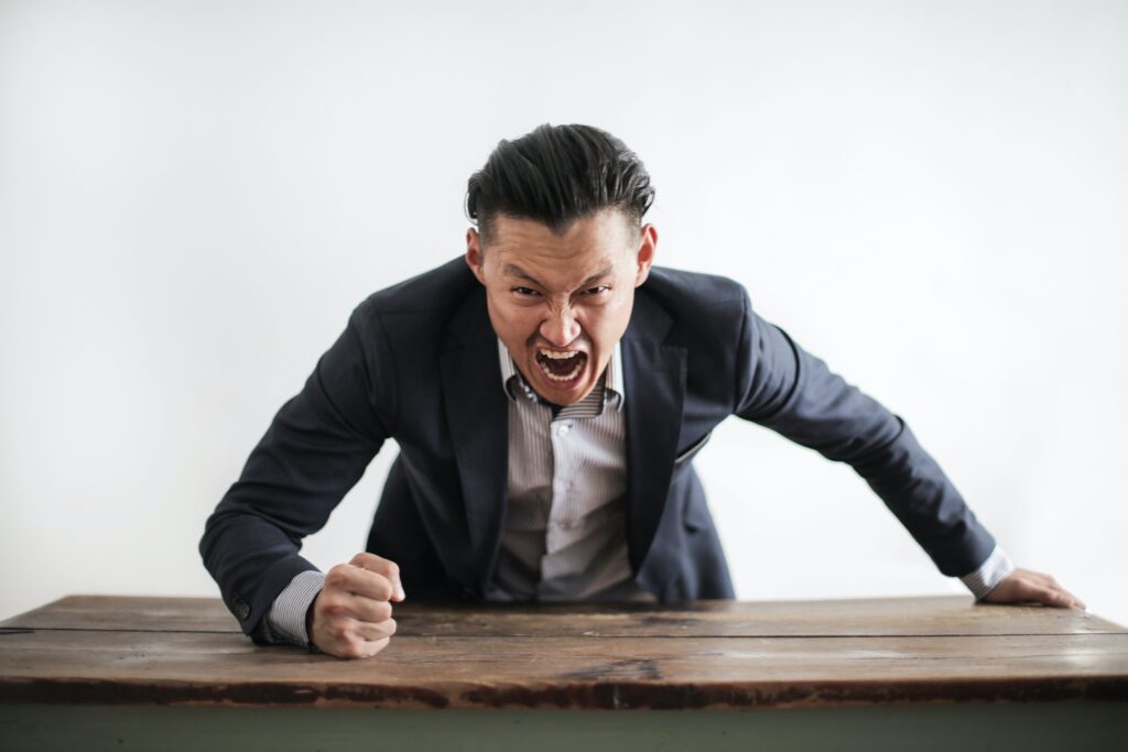 man pounding fist on table