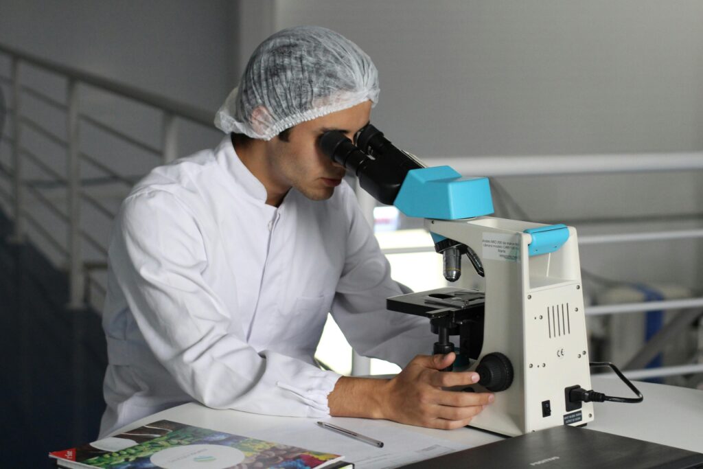 man using microscope