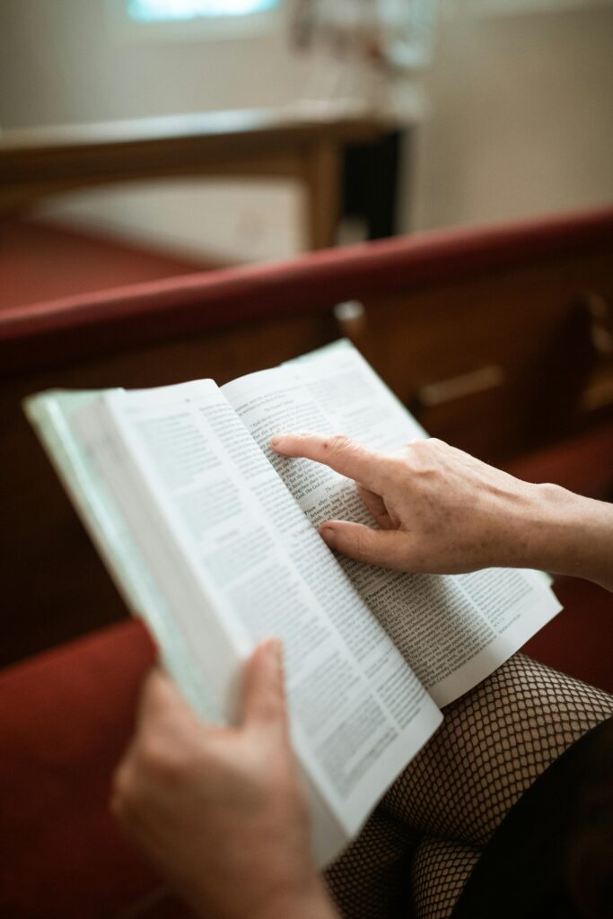 open bible with finger